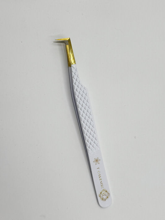 Eyebrow tweezer with white handle and gold accents on a light gray background